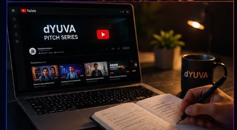 d’YUVA Pitch Series on a laptop with notebook and branded mug